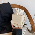 Chic beige woven drawstring bucket bag with pearl handle and golden chain strap - White