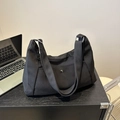 Large black nylon dumpling crossbody bag with adjustable wide straps and metal snap pocket - Black