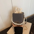 Mini drawstring bucket bag in grey woven texture with pearl handle and golden chain - Black