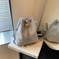 Silver-grey drawstring bucket bag with pleated texture and pearl butterfly accent - Butterfly Buckle Pearl Drawstring Style / Silver