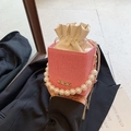 Red and white woven chain bucket bag with pearl handle and golden metal accents - Pink