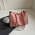 Pink large capacity faux leather tote bag with gold logo on a stylish desk background - Pink