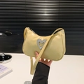 Pale yellow underarm bag featuring a sparkling rhinestone heart buckle and vegan leather - Yellow