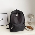 Minimalist black nylon campus backpack with white rope zipper pulls and multiple pockets - Black