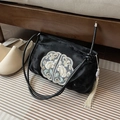 Black velvet shoulder bag with floral embroidery and tassel in a lifestyle setting - No Pendant / Black
