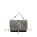 Grey suede shoulder bag with golden S-buckle and chain strap shown on white background - Gray