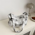 White corduroy crossbody bag with black floral print and matching coin purse charm - Black