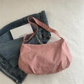Pink minimalist tote bag with textured fabric and adjustable strap in a casual setting - Pink Without Pendant