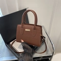 Dark brown faux crocodile leather tote bag with gold metal accents and shoulder strap - Brown