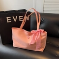 Bolso tote de tela rosa con lazo de cuadros y correa de hombro en un sofá negro - Rosa