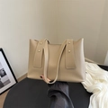 Minimalist beige tote bag with studded wide handles and white contrast stitching detail - Khaki