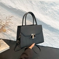 Classic black litchi pattern leather satchel with vertical quilting and gold T-clasp - Black