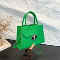 Bright green lychee grain leather crossbody bag with a polished metal T-lock - Green