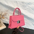 Vibrant pink lychee pattern crossbody bag with silver twist lock and shoulder strap - Pink