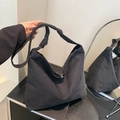 Minimalist black suede tote bag featuring a knotted shoulder strap and magnetic closure - Black