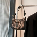 Retro leopard print hobo bag with black leather trim and gold metal buckle detail - Black
