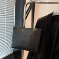 Minimalist black faux leather tote bag with exterior pocket and long shoulder straps - Black