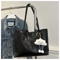 Close-up of black PU leather tote bag with vertical stitching and plush cloud charm - With Cloud Pendant / Black