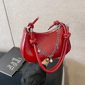 Red crescent shoulder bag featuring woven handle, silver chain and pearl heart pendant - Red