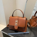 Braune Vintage-Handtasche aus hochwertigem Kunstleder mit silbernem Oval-Drehverschluss - Braun