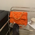 Quilted orange crossbody bag with a chunky acrylic chain and soft puffer texture - Orange