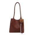 Vintage caramel brown leather tote bag with a cute bear charm on a plain white background - Bag / Brown