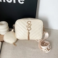 Beige V-quilted camera bag with wide strap, gold tassel logo, and mini round pouch - White