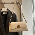Minimalist cream-colored underarm baguette bag with unique semi-circle metal buckle - White