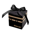 Detail of square black gift box with gold foil patterns and a satin ribbon bow - Black Box + Black Ribbon