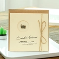 Vintage kraft greeting card with a bronze camera charm and rustic twine bow - Camera Style