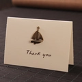 Vintage bronze sailboat charm on a cream white Thank You folding gift card - Sailboat
