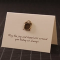 Vintage bronze alarm clock brooch pin pinned on a festive greeting card for gifts - Alarm Clock
