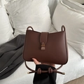 Detailed close-up of dark brown PU crossbody bag with vintage gold metal buckle - Coffee