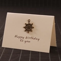 Retro bronze metal rudder charm on a Happy Birthday card for DIY gift decoration - Rudder