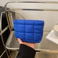 Quilted puffer cosmetic bag in bold Klein blue color with rectangular hand-held design - Blue