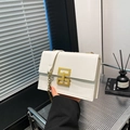 White faux leather crossbody bag with lychee texture and gold geometric metal buckle - White