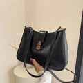 Vintage black leather underarm bag with elegant bronze metal buckle and sleek texture - Black