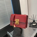 Red patent leather square chain bag featuring a gold H-shaped buckle and modern finish - Red