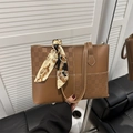Brown leather tote bag with checkered pattern and silk scarf on handles for office style - Tan