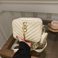 Beige quilted crossbody camera bag with gold letter logo and round coin purse charm - White