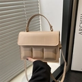 Detailed view of beige rectangle handbag with unique three-dimensional square patterns - Khaki