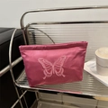 Pink satin cosmetic pouch featuring an elegant butterfly embroidery design for women - Rose Red