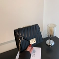 Elegant black quilted crossbody bag with gold chain strap and V-pattern stitching - Black