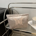 Elegant champagne gold satin cosmetic bag featuring a detailed butterfly embroidery - Light Pink