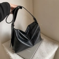 Large black faux leather hobo bag with wide adjustable shoulder strap and zipper closure - Black