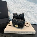 Elegant black quilted leather mini bag with a large bow detail and gold chain strap - Black
