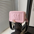 Pink rectangular crossbody bag with embossed letters and wide woven shoulder strap - Pink
