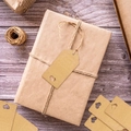 Brown kraft paper gift tags with heart cutout and jute rope on rustic wooden background - Style With 20m Hemp Rope