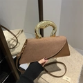 Brown asymmetric flap handbag with sculptural gold handle and sleek leather suede texture - Brown