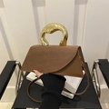 Brown geometric crossbody bag with a unique gold metal handle and leather shoulder strap - Dark Brown